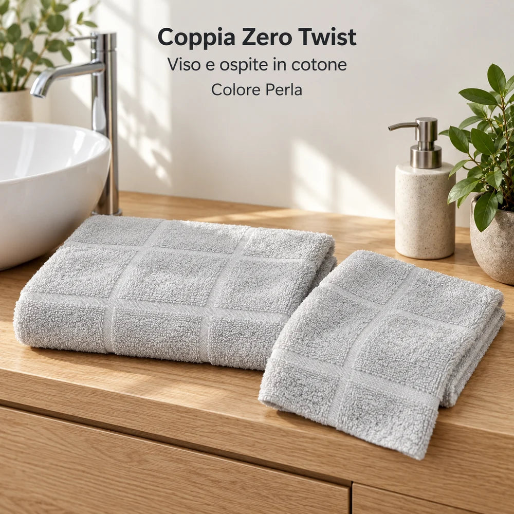 Coppia Zero Twist Perla: viso e ospite piegati e sfalsati vicino al lavabo. Foto illustrativa: Perla. Arredi e accessori esclusi.