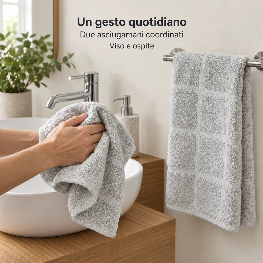 Ospite Perla fra le mani e asciugamano viso Perla aperto sul portasciugamani. Foto illustrativa: Perla. Arredi e accessori esclusi.
